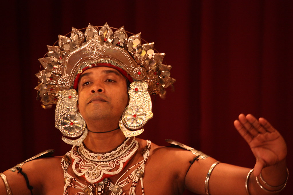 A Ves dancer in silver headdress mid-performance