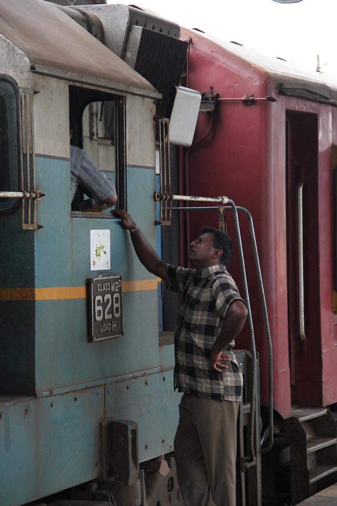 A driver talking with his engine crew at Galle station